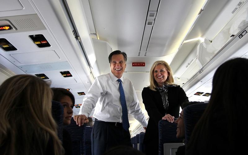Mitt Romney (L) and his wife Ann talk to members of the media aboard his campaign plane on Super Tuesday in Columbus, OH as he travels to Boston.